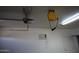 Garage interior with opener, hose reel, and storage space at 19950 W Cambridge Ave, Buckeye, AZ 85396