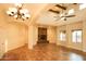 Spacious living room with high ceilings, a stone fireplace, and tile floors at 19950 W Cambridge Ave, Buckeye, AZ 85396