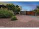 Landscaped side yard with a wooden gate and gravel at 19950 W Cambridge Ave, Buckeye, AZ 85396