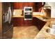 Modern kitchen with stainless steel appliances and granite countertops at 19950 W Cambridge Ave, Buckeye, AZ 85396