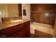 Bathroom with granite countertop, single sink, and dark wood cabinets at 19950 W Cambridge Ave, Buckeye, AZ 85396