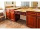 Bathroom with granite countertops, double sinks, and dark wood cabinets at 19950 W Cambridge Ave, Buckeye, AZ 85396