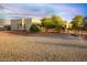 Landscaped backyard with a view of the house and a footbridge at 19950 W Cambridge Ave, Buckeye, AZ 85396