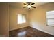 Well-lit bedroom featuring tile floors and ceiling fan at 19950 W Cambridge Ave, Buckeye, AZ 85396