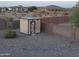 Small storage shed in the backyard with light blue roof at 19950 W Cambridge Ave, Buckeye, AZ 85396