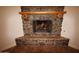 Rustic stone fireplace with a wooden mantel and gas logs at 19950 W Cambridge Ave, Buckeye, AZ 85396