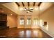 Bright living room with high ceilings, exposed beams, and a fireplace at 19950 W Cambridge Ave, Buckeye, AZ 85396