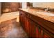 Bathroom with granite countertop, double sinks, and dark wood cabinets at 19950 W Cambridge Ave, Buckeye, AZ 85396