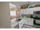 Modern kitchen with white cabinets, granite counters and stainless steel appliances at 35528 N Zachary Rd, San Tan Valley, AZ 85144