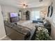 Spacious living room with leather sofas, wood flooring, and ceiling fan at 35528 N Zachary Rd, San Tan Valley, AZ 85144