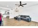 Open living room with wood-look floors, gray sectional sofa and kitchen views at 2030 E Duke Dr, Tempe, AZ 85283