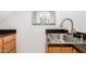 Small bathroom with a sink and wood cabinets at 2605 N 89Th Dr, Phoenix, AZ 85037
