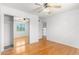 Hardwood floor bedroom with mirrored closet and ceiling fan at 2605 N 89Th Dr, Phoenix, AZ 85037