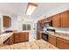 Spacious kitchen with granite countertops and wooden cabinets at 2605 N 89Th Dr, Phoenix, AZ 85037
