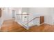 Upstairs hallway with hardwood floors and a staircase at 2605 N 89Th Dr, Phoenix, AZ 85037