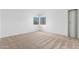 Well-lit bedroom with neutral walls and carpeted floors at 2605 N 89Th Dr, Phoenix, AZ 85037