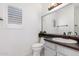 Updated bathroom with dark vanity and a modern sink at 2605 N 89Th Dr, Phoenix, AZ 85037
