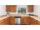 Bright kitchen with wood cabinets, granite counters, and stainless steel appliances at 2605 N 89Th Dr, Phoenix, AZ 85037
