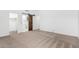 Bright bedroom featuring a barn door to the bathroom and ample closet space at 2605 N 89Th Dr, Phoenix, AZ 85037