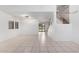 Spacious living room with tile floors and a view into the kitchen and stairs at 2605 N 89Th Dr, Phoenix, AZ 85037