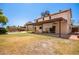 Back of house showing patio, grassy area, and pool at 2605 N 89Th Dr, Phoenix, AZ 85037