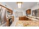Open kitchen boasting granite counters, stainless steel appliances, and wood cabinets at 2605 N 89Th Dr, Phoenix, AZ 85037
