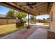 Covered patio with brick pavers, a swing, and access to the pool at 2605 N 89Th Dr, Phoenix, AZ 85037