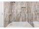 Bathroom with a shower and marble-look tile at 2605 N 89Th Dr, Phoenix, AZ 85037