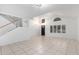 Bright and airy living room with tile floors and a staircase at 2605 N 89Th Dr, Phoenix, AZ 85037