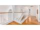 Upstairs hallway featuring hardwood floors and a bathroom at 2605 N 89Th Dr, Phoenix, AZ 85037