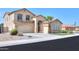 Two-story house with tan exterior, palm tree, and artificial turf at 1121 E Jahns Dr, Casa Grande, AZ 85122