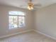 Light and airy bedroom featuring a large window and ceiling fan at 1121 E Jahns Dr, Casa Grande, AZ 85122
