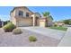 Two story house with a tan exterior and a three-car garage at 1121 E Jahns Dr, Casa Grande, AZ 85122