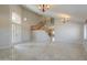 Two-story entryway with tile flooring and an open staircase at 1121 E Jahns Dr, Casa Grande, AZ 85122