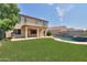 Two-story home with a large backyard, pool, and artificial turf at 1121 E Jahns Dr, Casa Grande, AZ 85122