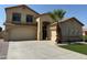Two-story house with a tan exterior and a three-car garage at 1121 E Jahns Dr, Casa Grande, AZ 85122