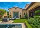 Inviting backyard with a pool, lush grass, and seating area at 20226 N 101St Way, Scottsdale, AZ 85255