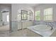 Elegant bathroom with marble finishes, free-standing tub, and walk-in shower at 20226 N 101St Way, Scottsdale, AZ 85255