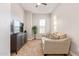 Living room with a sofa, media console, and natural light at 10835 E Tesla Ave, Mesa, AZ 85212