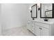 Elegant bathroom featuring double sinks, marble flooring and large mirrors at 7245 S 75Th Dr, Laveen, AZ 85339
