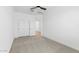 Bright bedroom with neutral carpet, double door closet, and ceiling fan at 7245 S 75Th Dr, Laveen, AZ 85339