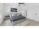 Main bedroom with a gray bed, striped bedding, and modern artwork at 7245 S 75Th Dr, Laveen, AZ 85339
