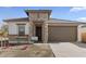 One-story home with stone accents and a two-car garage at 7245 S 75Th Dr, Laveen, AZ 85339