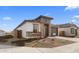 Modern home with stone and stucco exterior, two-car garage and landscaping at 7245 S 75Th Dr, Laveen, AZ 85339