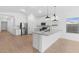 Modern kitchen with white cabinets, stainless steel appliances and an island at 7245 S 75Th Dr, Laveen, AZ 85339