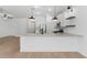 Open concept kitchen with white cabinets, stainless steel appliances and a breakfast bar at 7245 S 75Th Dr, Laveen, AZ 85339