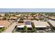 Aerial view of house with solar panels, pool, and patio at 9313 E Crystal Dr, Sun Lakes, AZ 85248