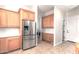 Kitchen with stainless steel refrigerator and access to laundry area at 4213 E Edgemont Ave, Phoenix, AZ 85008