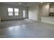 Open living room with grey carpet and tile flooring at 13213 E Larrea Ln, Florence, AZ 85132