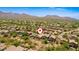 Aerial view of a house in a residential area with desert landscape and mountain views at 10522 E Morning Star Dr, Scottsdale, AZ 85255